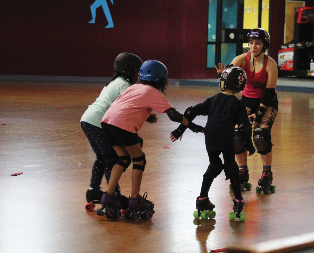 Falling for Derby - Sophia Palmer (17, Brown) -a.k.a. “Sockeye Slammin” is using her experience to teach younger girls the types of falls in roller derby. There are little things all the time that made me really glad I joined the team, Sophia said. Photo credit: Sam Sims